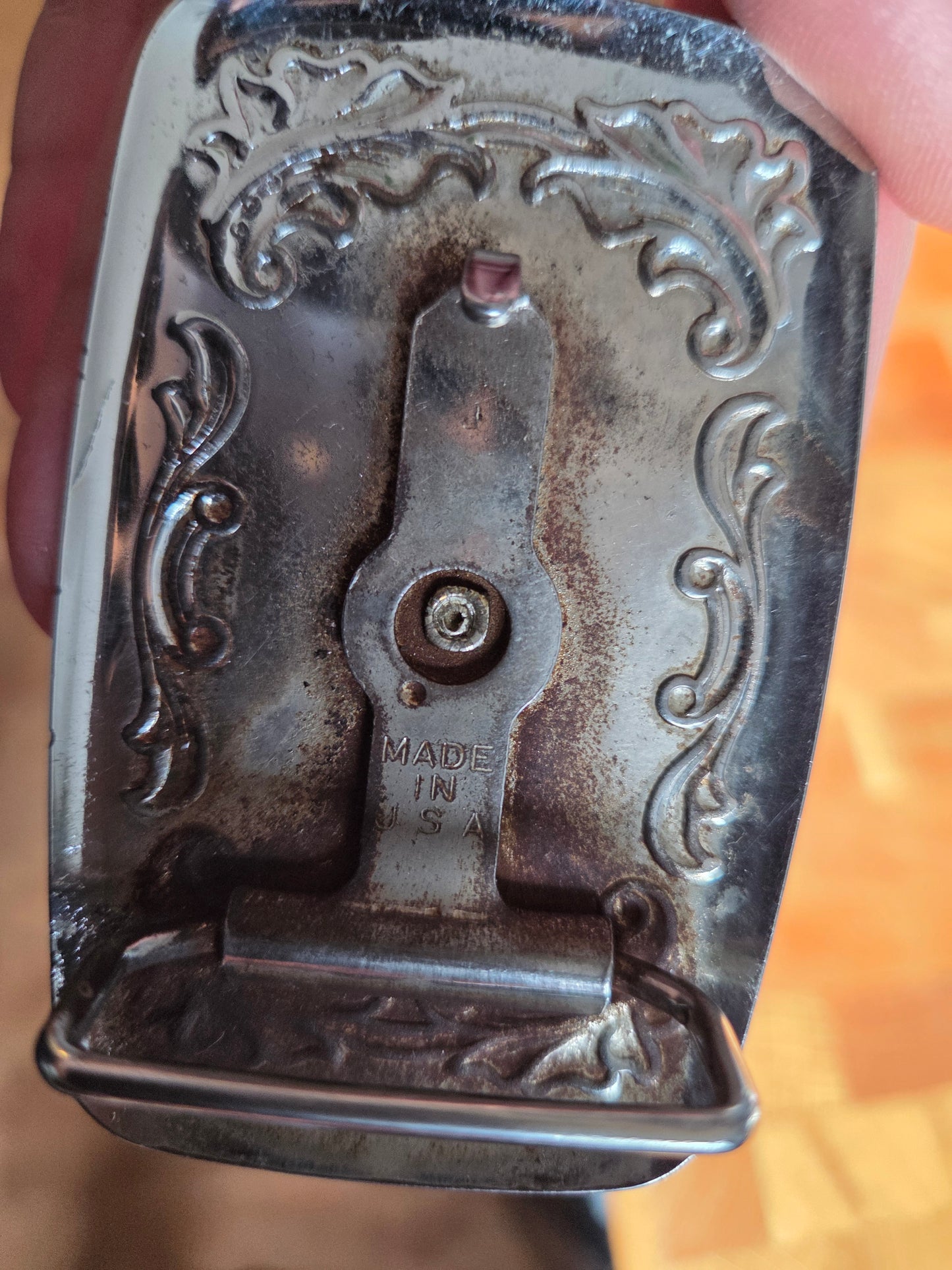 Metal belt buckle with bucking bronco cowboy and tan belt